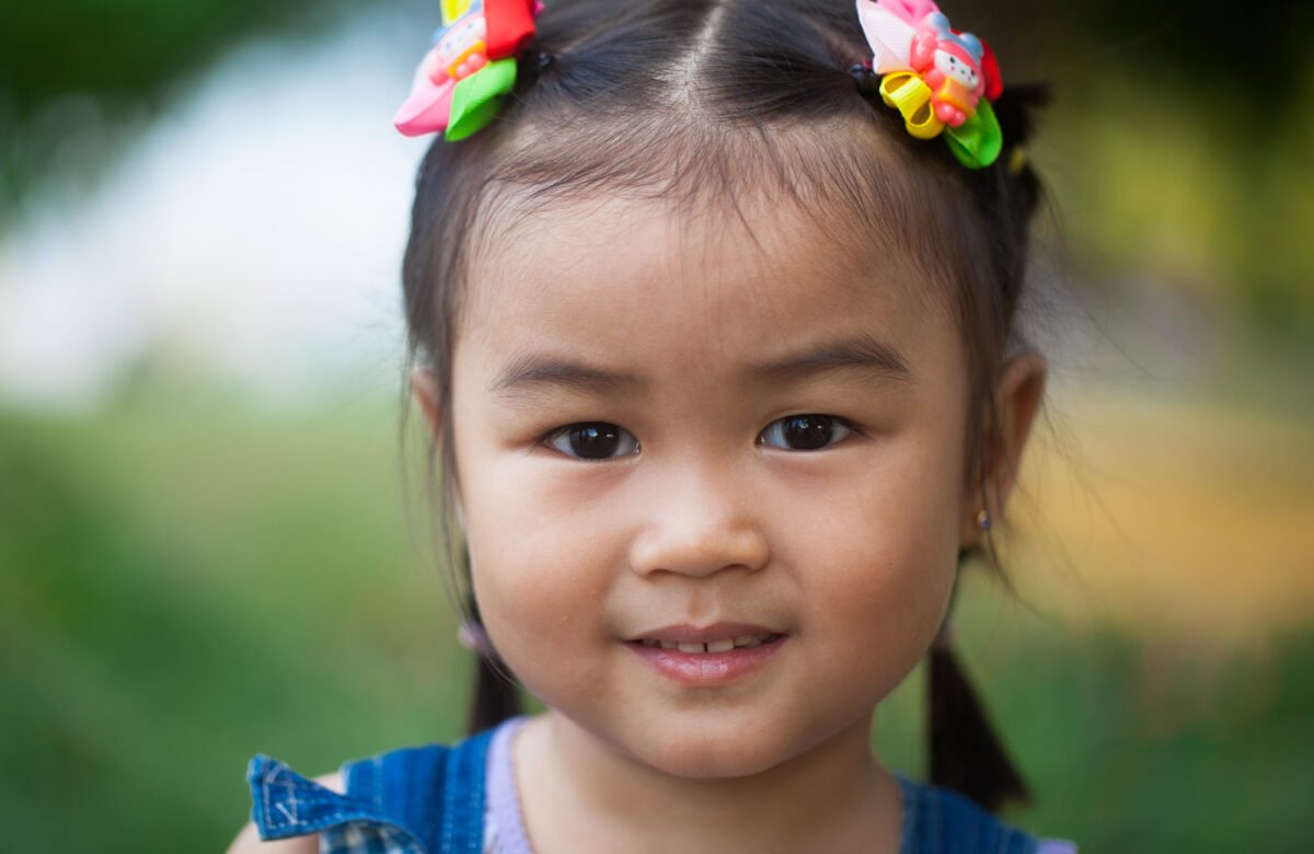 Face of Qatar portrait, green park, kid from Malaysia