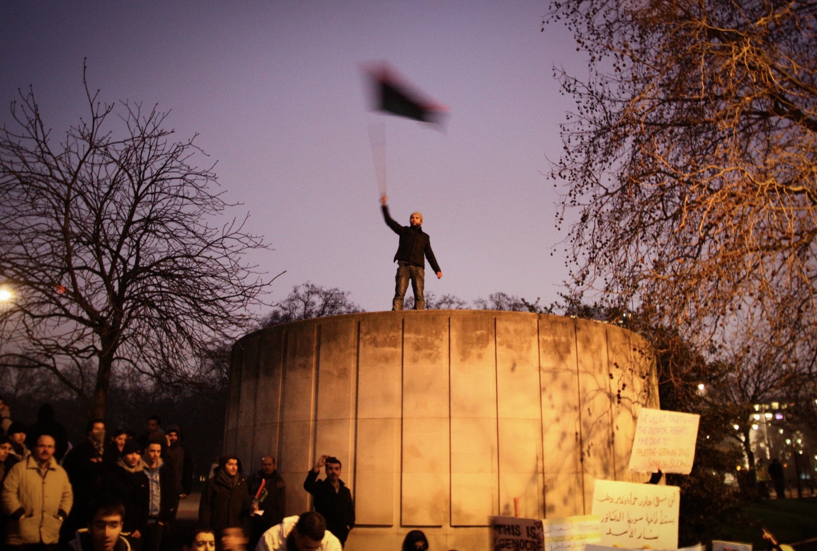 Libya's uprising protest, London, UK, Man waving the Libyan flag in front of the Libyan Embassy in London.