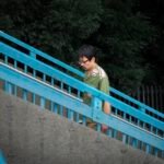 Japanese man climbing stairs, overcast day in Tokyo, Japan.
