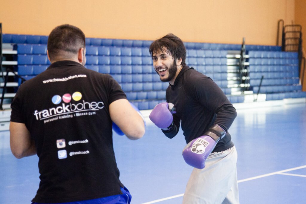 Fahad Khalid Al-Thani training with his coach during a lifestyle brand photoshoot.